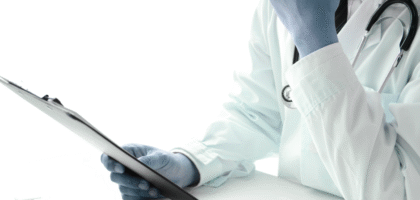 Doctor wearing a white coat and stethoscope, holding a clipboard