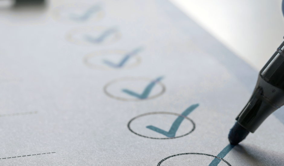 Checklist on paper with circled checkmarks as a pen completes the final item.